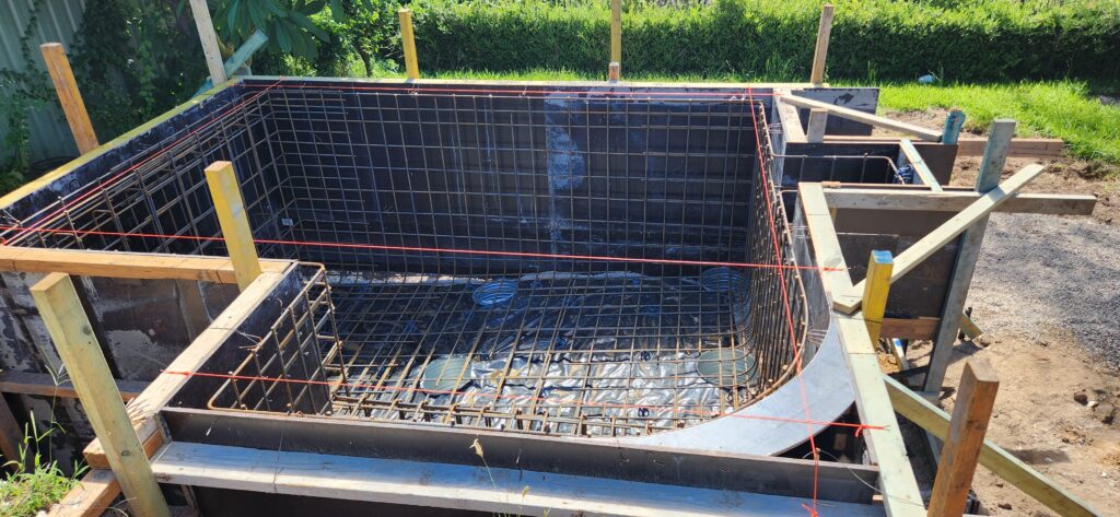 Structural engineer inspecting reinforced concrete pool slab design in Sutherland Shire